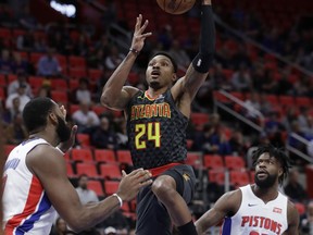 Atlanta Hawks guard Kent Bazemore (24) makes a layup defended by Detroit Pistons center Andre Drummond, left, during the first half of an NBA basketball game, Friday, Nov. 10, 2017, in Detroit. (AP Photo/Carlos Osorio)