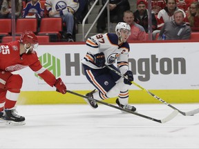 Edmonton Oilers center Connor McDavid (97) controls the puck as he skates by Detroit Red Wings defenseman Mike Green (25) during the first period of an NHL hockey game, Wednesday, Nov. 22, 2017, in Detroit. (AP Photo/Carlos Osorio)