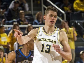 Michigan forward Moritz Wagner (13) points to his bench after making a basket in the first half of an NCAA college basketball game against UC Riverside at Crisler Center in Ann Arbor, Mich., Sunday, Nov. 26, 2017. (AP Photo/Tony Ding)