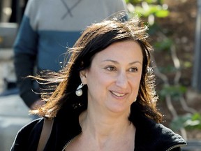 FILE -- This photo taken on April 4, 2016 shows Daphne Caruana Galizia, the Maltese investigative journalist who exposed her island nation's links with the so-called Panama Papers. Galizia was killed on Monday, Oct. 16, 2017, when a bomb destroyed her car as she was driving near her home in Mosta, a town outside Valletta, Malta's capital. Malta observes a national day of mourning Friday, Nov. 3, 2017, as the funeral of slain journalist Daphne Caruana Galizia takes place in the Mediterranean island's largest church. (AP Photo/Jon Borg)