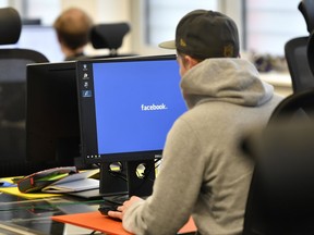 Employees of the Competence Call Center (CCC) work for the Facebook Community Operations Team in Essen, Germany, Thursday, Nov. 23, 2017. About 500 people control and delete facebook content if it does not apply the facebook standards in the new center in Essen. (AP Photo/Martin Meissner)