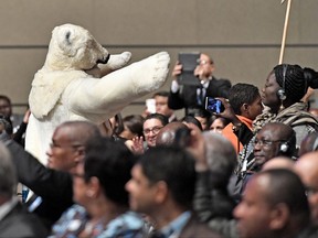 A man in a polar bear costume walks between the delegates during the opening of the COP 23 Fiji UN Climate Change Conference in Bonn, Germany, Monday, Nov. 6, 2017. The two-week meeting that started Monday is the first major conference on climate change since President Donald Trump said that the U.S. will pull out of the Paris accord unless his administration can secure a better deal. Other nations are vowing to press ahead with the accord.  (AP Photo/Martin Meissner)