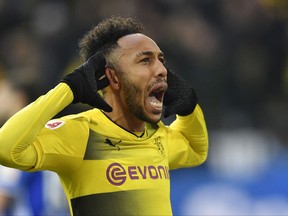 Dortmund's Pierre-Emerick Aubameyang celebrates scoring the opening goal during the German Bundesliga soccer match between Borussia Dortmund and FC Schalke 04 in Dortmund, Germany, Saturday, Nov. 25, 2017. (AP Photo/Martin Meissner)