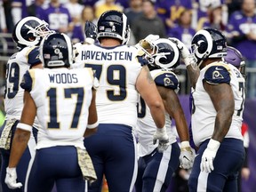 Los Angeles Rams running back Todd Gurley, center, celebrates with teammates after scoring on a 6-yard touchdown run during the first half of an NFL football game against the Minnesota Vikings, Sunday, Nov. 19, 2017, in Minneapolis. (AP Photo/Bruce Kluckhohn)