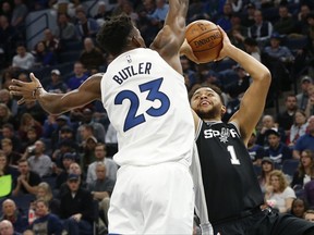 San Antonio Spurs' Kyle Anderson, right, shoots as Minnesota Timberwolves' Jimmy Butler defends during the first half of an NBA basketball game Wednesday, Nov. 15, 2017 in Minneapolis. (AP Photo/Jim Mone)