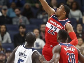 Washington Wizards' Otto Porter Jr. (22) shoots as Minnesota Timberwolves' Gorgui Dieng, left, of Senegal looks on in the first half of an NBA basketball game Tuesday, Nov. 28, 2017, in Minneapolis. (AP Photo/Jim Mone)