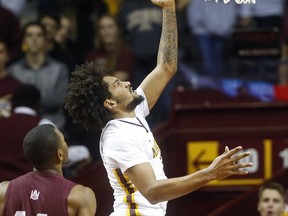 Minnesota's Jordan Murphy, right, lays up in front of Alabama A&M's Matthew Cotton in the first half of an NCAA college basketball game Tuesday, Nov. 21, 2017, in Minneapolis. (AP Photo/Jim Mone)