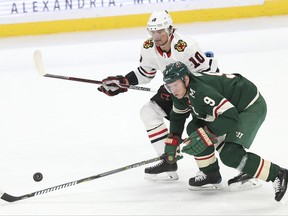 Minnesota Wild's Mikko Koivu (9) and Chicago Blackhawks' Patrick Sharp (10) look toward a loose puck in the first period of an NHL hockey game Saturday, Nov. 4, 2017, in St. Paul, Minn. AP Photo/Stacy Bengs)
