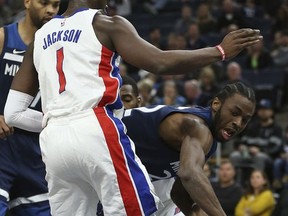 Minnesota Timberwolves forward Andrew Wiggins (22) passes the ball around Detroit Pistons guard Reggie Jackson (1) in the first half of an NBA basketball game, Sunday, Nov. 19, 2017, in Minneapolis. (AP Photo/Stacy Bengs)