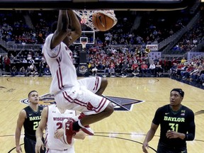 Wisconsin's Khalil Iverson dunks the ball during the first half of an NCAA college basketball game against Baylor in the Hall of Fame Classic, Monday, Nov. 20, 2017, in Kansas City, Mo. (AP Photo/Charlie Riedel)