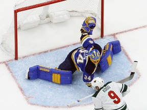Minnesota Wild's Mikko Koivu, of Finland, is unable to score past St. Louis Blues goalie Jake Allen, top, during the first period of an NHL hockey game Saturday, Nov. 25, 2017, in St. Louis. (AP Photo/Jeff Roberson)