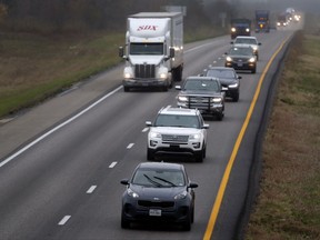 In this photo made Wednesday, Nov. 1, 2017, a driver stays in the passing lane as traffic accumulates behind along I-70 in Montgomery County, Mo. Many states have laws against driving in the left lane except for passing or turning left, which are often ignored by drivers, leading to annoying and dangerous bottlenecks that some experts say are as bad as driving too fast because people get trapped behind and become frustrated prompting some to drive more aggressively. (AP Photo/Jeff Roberson)