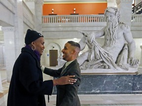 Newly elected city council members Phillipe Cunningham, right, and Andrea Jenkins greet each other prior to an interview Thursday, Nov. 9, 2017, at City Hall in Minneapolis. The two black transgender representatives-elect add to what advocacy groups have described as a banner election for transgender people in public office. (AP Photo/Jim Mone)