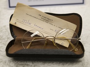 Glasses of John Lennon with a recipe by optometrist Gary Tracy are displayed at the police headquarters in Berlin, Tuesday, Nov. 21, 2017, after German police have arrested a man suspected of handling stolen objects from the estate of John Lennon, including diaries which were stolen from Lennon's widow, Yoko Ono, in New York in 2006. (AP Photo/Markus Schreiber)
