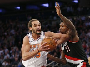 New York Knicks center Joakim Noah (13), making his season debut after a suspension for performance enhancing drugs, goes up against Portland Trail Blazers forward Ed Davis (17) during the first half of an NBA basketball game in New York, Monday, Nov. 27, 2017. (AP Photo/Kathy Willens)