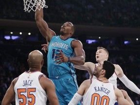 Charlotte Hornets' Dwight Howard (12) drives past New York Knicks' Jarrett Jack (55), Enes Kanter (00) and Kristaps Porzingis during the first half of an NBA basketball game Tuesday, Nov. 7, 2017, in New York. (AP Photo/Frank Franklin II)