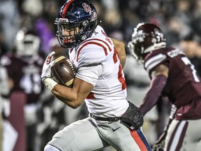 Mississippi running back Jordan Wilkins (22) scores in the first quarter against Mississippi State during an NCAA college football game in Starkville, Miss., Thursday, Nov. 23, 2017. (Bruce Newman/The Oxford Eagle via AP)