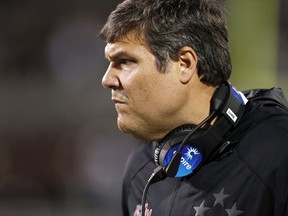 Mississippi coach Matt Luke looks at his players on the field during the first half of an NCAA college football game against Mississippi State in Starkville, Miss., Thursday, Nov. 23, 2017. Mississippi won 31-28. (AP Photo/Rogelio V. Solis)