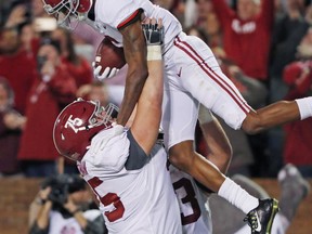 Alabama offensive lineman Bradley Bozeman (75) hoists wide receiver DeVonta Smith (6) as they celebrate Smith's 26-yard touchdown pass reception for the go-ahead score during the fourth quarter of an NCAA college football game in Starkville, Miss., Saturday, Nov. 11, 2017. Alabama won 31-24. (AP Photo/Rogelio V. Solis)