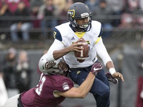Northern Arizona quarterback Stone Smart, top, is sacked by Montana defensive end Chris Favoroso (43) in the first half of an NCAA college football game Saturday, Nov. 4, 2017, in Missoula, Mont. (AP Photo/Patrick Record)