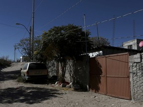 The gate stands closed at the home where three girls were attacked in a low-income neighborhood of Ciudad Juarez, Mexico, Friday, Nov. 26, 2017. A 12-year-old girl is dead after an assailant attacked her and raped her two young sisters inside this home on Wednesday, near a desert area where the bodies of numerous young women were found dumped in the 1990s. (AP Photo/Christian Torres)