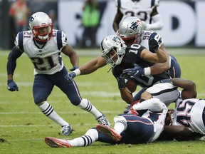 Oakland Raiders wide receiver Seth Roberts (10) is tackled by New England Patriots defensive end Trey Flowers (98) during the second half of an NFL football game, Sunday, Nov. 19, 2017, in Mexico City. (AP Photo/Eduardo Verdugo)