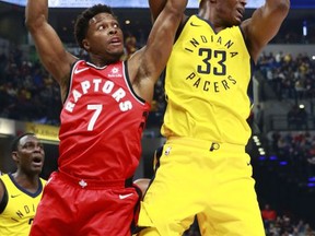 Toronto Raptors guard Kyle Lowry (7) tries to take the basketball from Indiana Pacers center Myles Turner during the first half of an NBA basketball game, Friday, Nov. 24, 2017, in Indianapolis. (AP Photo/R Brent Smith)