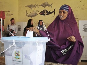 A woman casts her vote in the presidential election in Hargeisa, in the semi-autonomous region of Somaliland, in Somalia Monday, Nov. 13, 2017. More than 700,000 registered voters across Somaliland are expected to cast their votes Monday to elect their fifth president, as the ruling party faces a strong challenge from opposition candidates. (AP Photo/Barkhad Kaariye)2