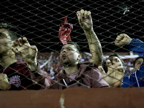 In this Oct. 31, 2017 photo, Argentina's Lanus fans cheer for their team during a semifinals Copa Libertadores soccer match against Argentina's River Plate in Buenos Aires, Argentina. Lanus, a small soccer club from Buenos Aires suburbs, qualified for the first time in its history to the final of the Copa Libertadores, and will face Brazil's Gremio in the Copa Libertadores final on Nov. 22 and 29. (AP Photo/Natacha Pisarenko)