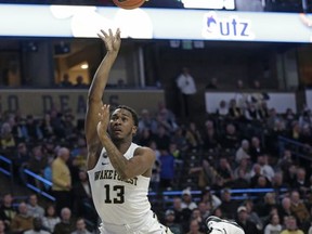Wake Forest's Bryant Crawford (13) drives into Georgia Southern's Jake Allsmiller (10) while shooting during the first half of an NCAA college basketball game in Winston-Salem, N.C., Friday, Nov. 10, 2017. (AP Photo/Chuck Burton)