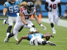 Carolina Panthers' Kaelin Clay (12) tries to recover his fumble as Atlanta Falcons' Brooks Reed (50) closes in during the first half of an NFL football game in Charlotte, N.C., Sunday, Nov. 5, 2017. The Panthers recovered the ball. (AP Photo/Mike McCarn)