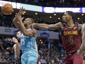 Charlotte Hornets' Kemba Walker (15) is fouled by Cleveland Cavaliers' Iman Shumpert (4) during the first half of an NBA basketball game in Charlotte, N.C., Wednesday, Nov. 15, 2017. (AP Photo/Chuck Burton)