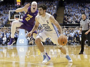 North Carolina's Luke Maye (32) dribbles while Northern Iowa's Klint Carlson (2) defends during the first half of an NCAA college basketball game in Chapel Hill, N.C., Friday, Nov. 10, 2017. (AP Photo/Gerry Broome)