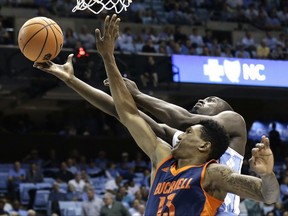 North Carolina's Theo Pinson drives to the basket while Bucknell's Bruce Moore (13) defends during the first half of an NCAA college basketball game in Chapel Hill, N.C., Wednesday, Nov. 15, 2017. (AP Photo/Gerry Broome)