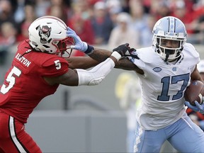 North Carolina's Anthony Ratliff-Williams (17) runs the ball while North Carolina State's Johnathan Alston (5) tries to tackle during the first half of an NCAA college football game in Raleigh, N.C., Saturday, Nov. 25, 2017. (AP Photo/Gerry Broome)