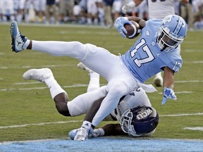 North Carolina's Anthony Ratliff-Williams (17) scores a touchdown while Western Carolina's Shamon Elliott tackles during the first half of an NCAA college football game in Chapel Hill, N.C., Saturday, Nov. 18, 2017. (AP Photo/Gerry Broome)