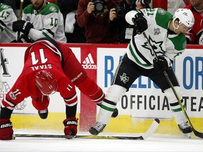 Carolina Hurricanes' Jordan Staal (11) collides with Dallas Stars' Antoine Roussel (21) during the first period of an NHL hockey game, Monday, Nov. 13, 2017, in Raleigh, N.C. (AP Photo/Karl B DeBlaker)