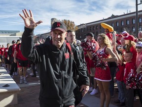 Nebraska head coach Mike Riley waves to fans as he walks into the stadium during the Unity Walk with his team before an NCAA college football game against Iowa in Lincoln, Neb., Friday, Nov. 24, 2017. (AP Photo/John Peterson)