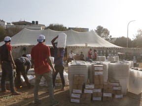 In this Nov. 9, 2017, photo, workers from Nepal's election commission load polling materials to be delivered to various districts for the upcoming legislative election in Kathmandu, Nepal. Eleven years after Nepal began its journey toward democracy by stripping its authoritarian king of his powers, the nation's 30 million people will finally get a say in running their local regions, giving voice to those who feel overlooked in a country with diverse ethnic groups and cultures. (AP Photo/Niranjan Shrestha)