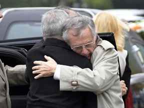 Jimmy Drake, right, receives a hug as mourners pay their last respects after the loss of his son, Darren Drake, before the funeral mass at the Church of the Ascension in New Milford, N.J., Monday, Nov. 6, 2017. Drake was killed Tuesday, Oct. 31, after a man drove a rented pick-up truck down a New York City bicycle path. (AP Photo/Bill Kostroun)