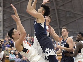 Princeton forward Alec Brennan, left, is called for a blocking foul as Brigham Young guard Elijah Bryant goes up with a shot during the first half of an NCAA college basketball game, Wednesday, Nov. 15, 2017, in Princeton, N.J. (AP Photo/Bill Kostroun)