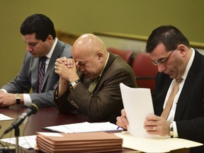 Former Paterson Mayor Jose "Joey" Torres lowers his head down before his sentencing begins Tuesday, Nov. 14, 2017, in Jersey City, N.J. He was sentenced to five years of prison time for directing city employees to do work at a warehouse leased by his daughter and nephew (Tariq Zehawi/The Record via AP, Pool)