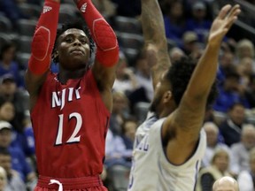 NJIT guard Anthony Tarke (12) shoots as Seton Hall guard Myles Powell (13) tries to block the shot during the first half of an NCAA college basketball game, Saturday, Nov. 18, 2017, in Newark, N.J. (AP Photo/Julio Cortez)