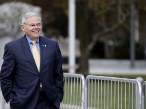 U.S. Sen. Bob Menendez leaves the Martin Luther King Jr. Federal Courthouse after stopping in to appear on his corruption trial, Tuesday, Nov. 14, 2017, in Newark, N.J. Jury deliberations in the bribery trial of Menendez continued Tuesday. (AP Photo/Julio Cortez)