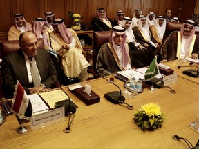 Saudi Arabia's Foreign Minister Adel al-Jubeir, center, and Egyptian Foreign Minister Sameh Shoukry, left, meet at the Arab League headquarters in Cairo, Egypt, Sunday, Nov. 19, 2017. The foreign ministers of four Arab nations are meeting in Cairo to discuss a draft Saudi declaration on countering Iranian influence in Arab affairs. (AP Photo/Nariman El-Mofty)