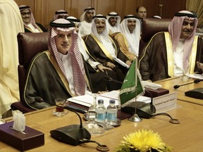 Saudi Arabia's Foreign Minister Adel al-Jubeir, left, and his Bahraini counterpart, Sheik Khalid Bin Ahmed Al Khalifa, right, meet with foreign ministers at the Arab League headquarters in Cairo, Egypt, Sunday, Nov. 19, 2017. The foreign ministers of Saudi Arabia, Egypt, the United Arab Emirates and Bahrain are meeting in Cairo to discuss a draft Saudi declaration on countering Iranian influence in Arab affairs. The four Arab nations have been boycotting the Gulf Arab nation of Qatar since June in part over its warm ties with Iran. (AP Photo/Nariman El-Mofty)