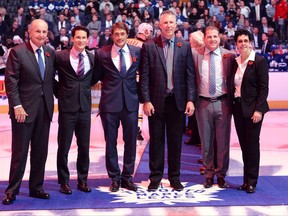 2017 Hockey Hall of Fame inductees, left to right, Jeremy Jacobs, Paul Kariya, Teemu Selanne, Dave Andreychuk, Mark Recchi and Danielle Goyette pose for a photo during a pre-game ceremony ahead of NHL hockey action between the Boston Bruins at Toronto Maple Leafs in Toronto on Friday, November 10, 2017. THE CANADIAN PRESS/Nathan Denette