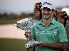 Patrick Cantlay holds his winning trophy following the final round playoff of the Shriners Hospitals for Children Open golf tournament from TPC Summerlin, Sunday, Nov 5, 2017, in Las Vegas. (AP Photo/L.E. Baskow)