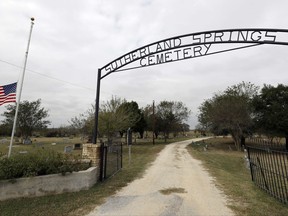 A flag flies at half-staff outside the entrance to the Sutherland Springs Cemetery Thursday, Nov. 9, 2017, in Sutherland Springs, Texas.  The people of Sutherland Springs have not held news conferences, they haven't made appearances on network morning television shows, and while they've been polite to the media, they're not exactly forthcoming(AP Photo/David J. Phillip)