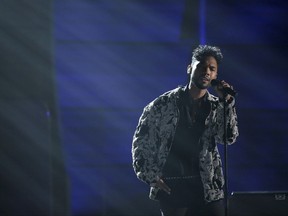 FILE - In this Feb. 15, 2016 file photo, Miguel performs at the 58th annual Grammy Awards in Los Angeles.  Grammy-winning singer Miguel says he felt angered after hearing numerous stories of immigrants being deprived of meals and relegated to harsh living conditions inside some detention centers across the country. He is looking to shed light on the alleged treatment of immigrants at the facilities and  has taken to his social media, spoken publicly and recently headlined a free #SchoolsNotPrisons concert in California to bring more awareness toward the issues. (Photo by Matt Sayles/Invision/AP, File)